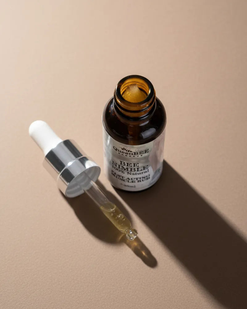 Brown glass dropper bottle with a white label on a beige background