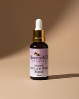 QueenBEE Secrets organic camelilla & rosehip serum bottle on a beige background