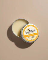 QueenBEE Secrets BEE Active muscle balm in a metal tin on a beige background
