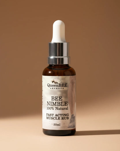 Bottle of Queen Bee Secrets Bee Nimble muscle rub on a neutral background