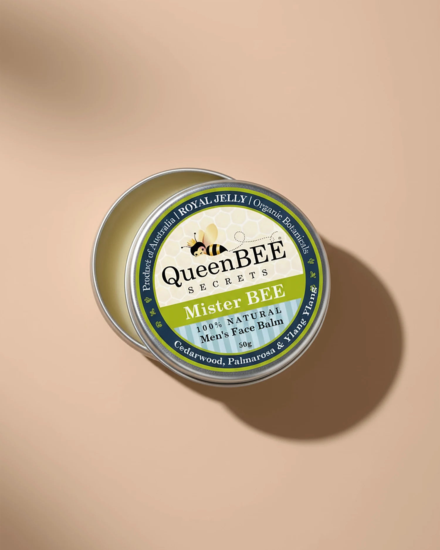 QueenBEE Secrets Mister BEE men's face balm tin on a beige background