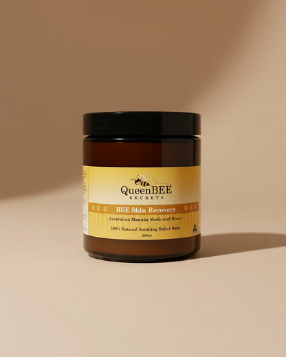 Jar of Queen Bee Skin Recovery balm on a beige background