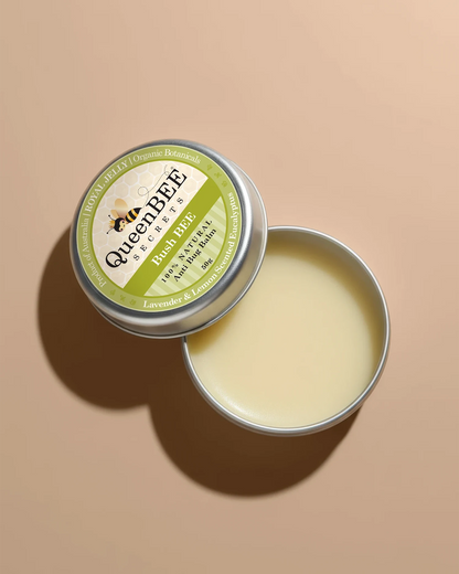 Open tin of Queen Bee balm on a beige background