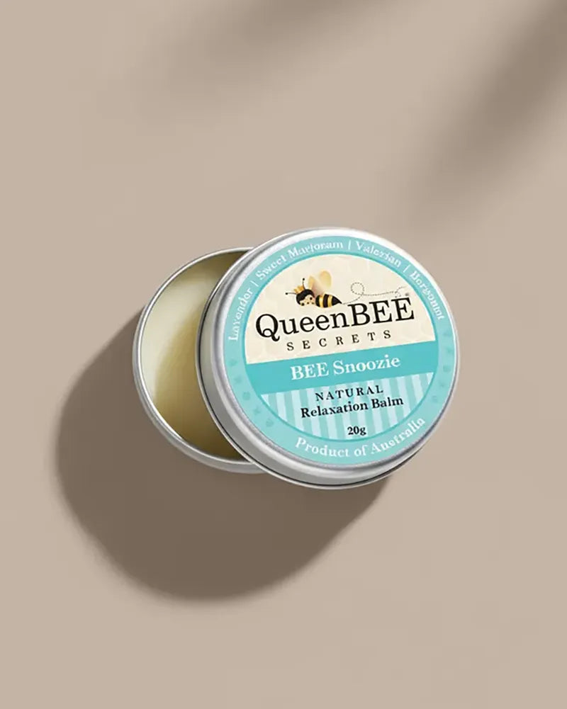 QueenBEE Secrets BEE Snoozie balm in a tin on a beige background